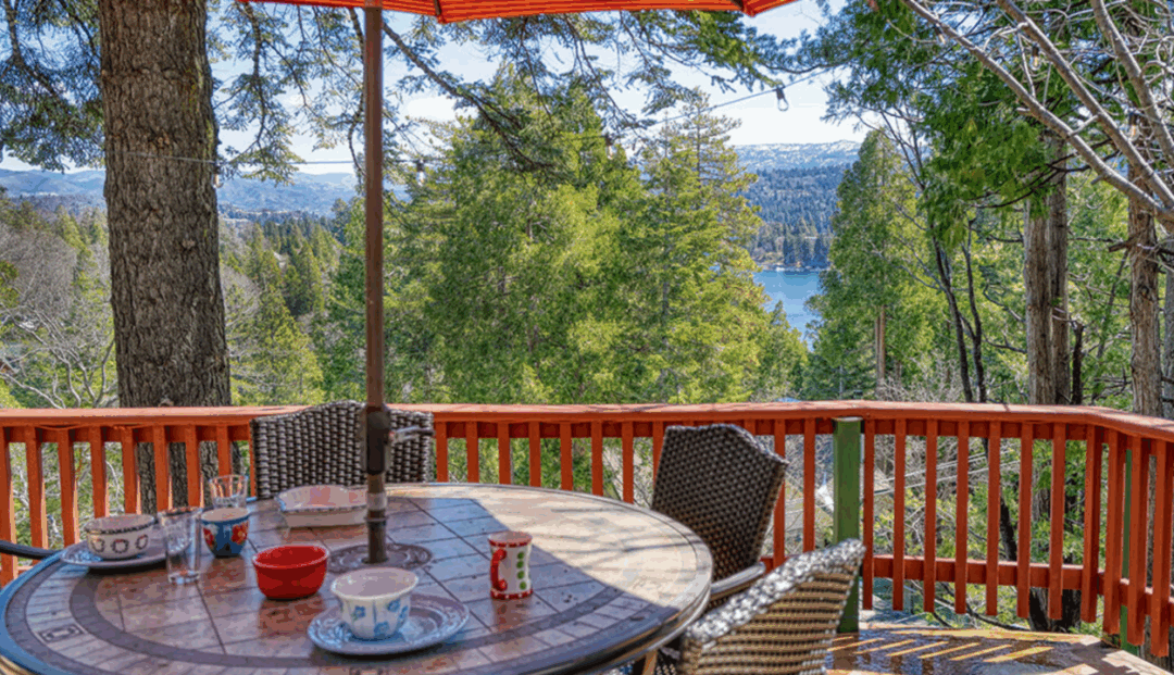 Scenic deck with forest and lake view.